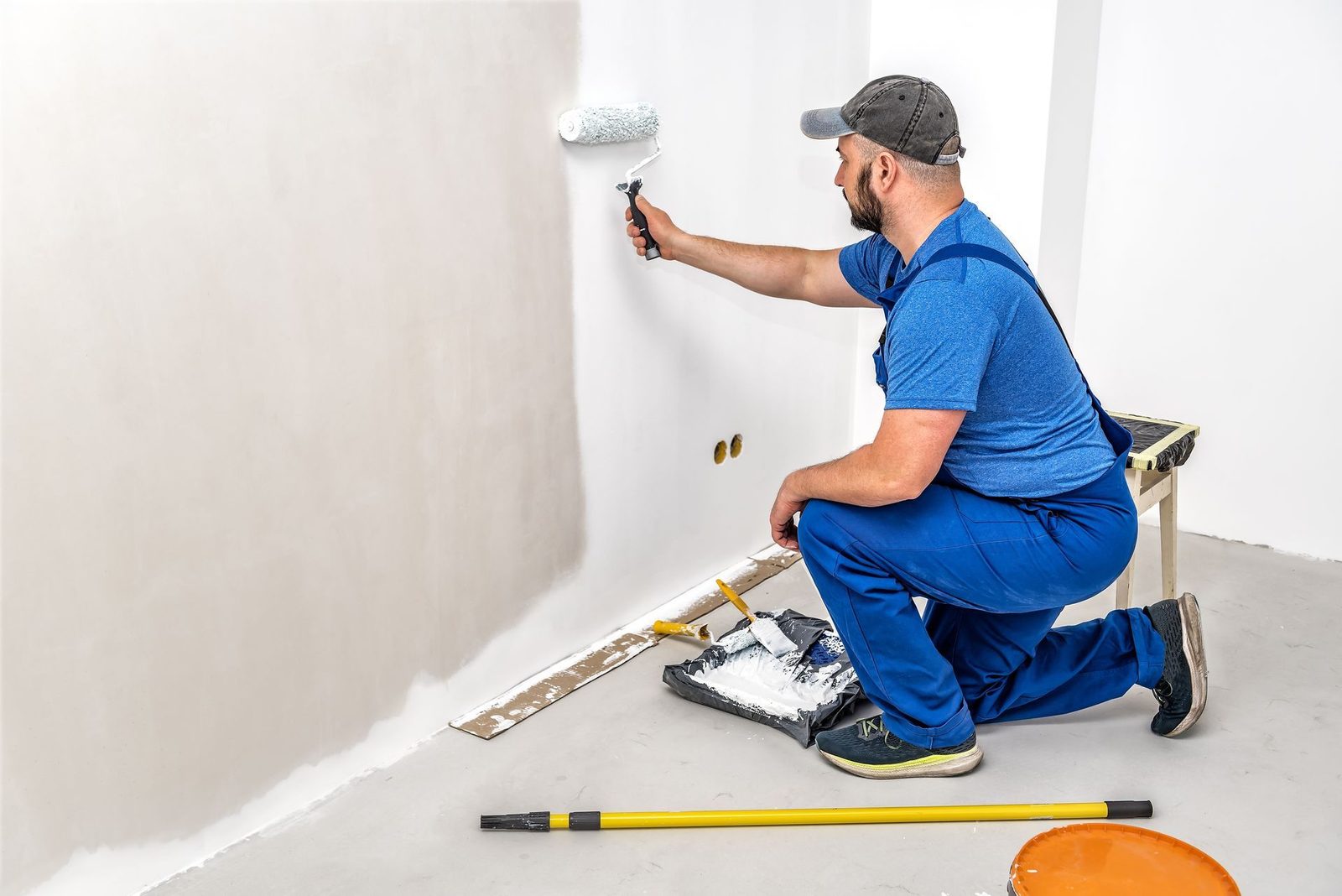 Painter applying a fresh coat to an interior wall