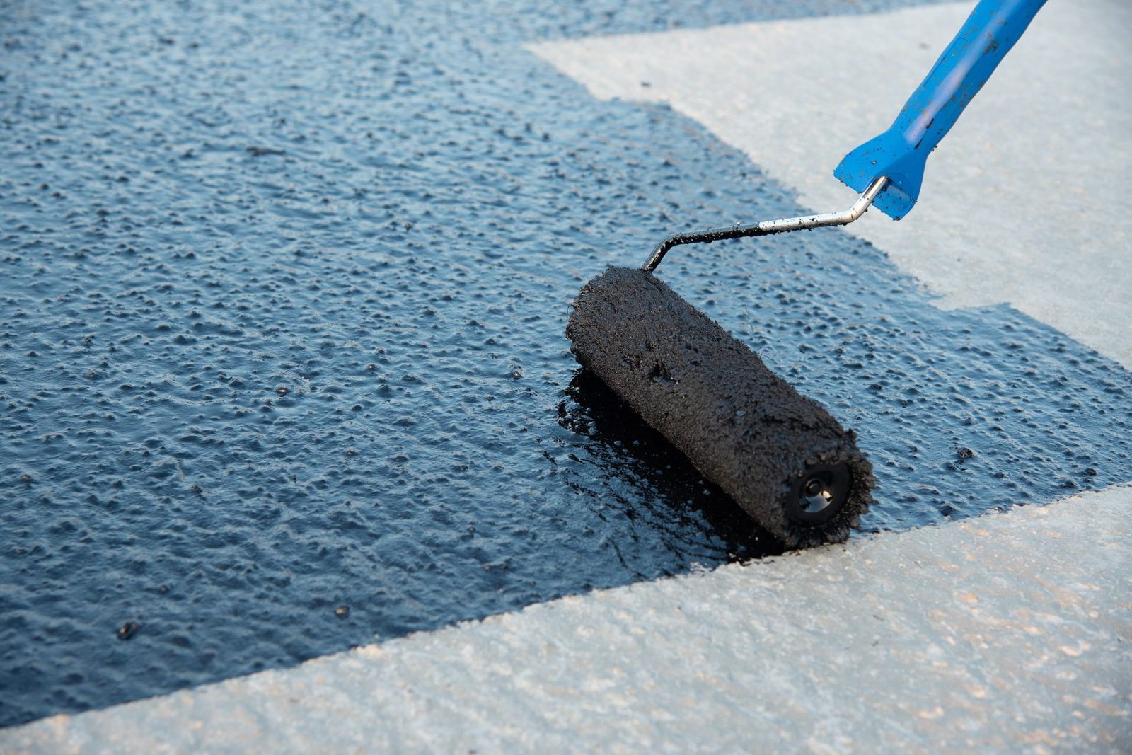 Protective coating being applied to concrete